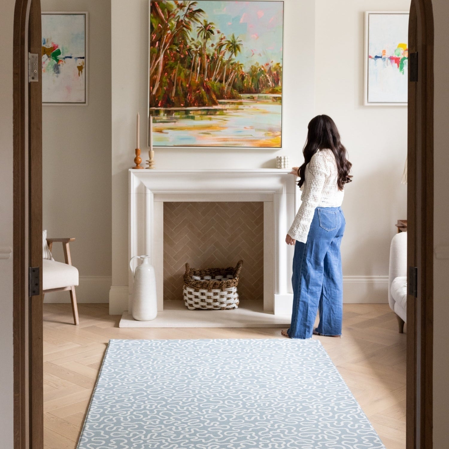 A sophisticated living room interior featuring a large soft blue rug-like playmat