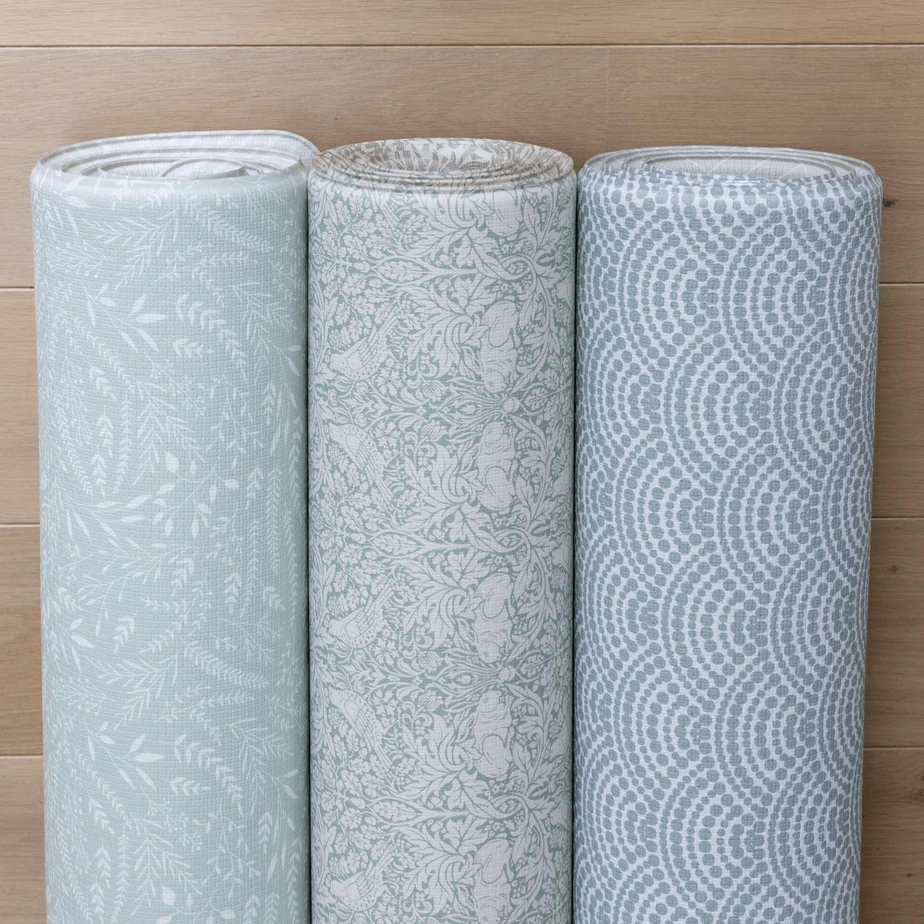 Soft squishy playmats rolled up in green and blue colours