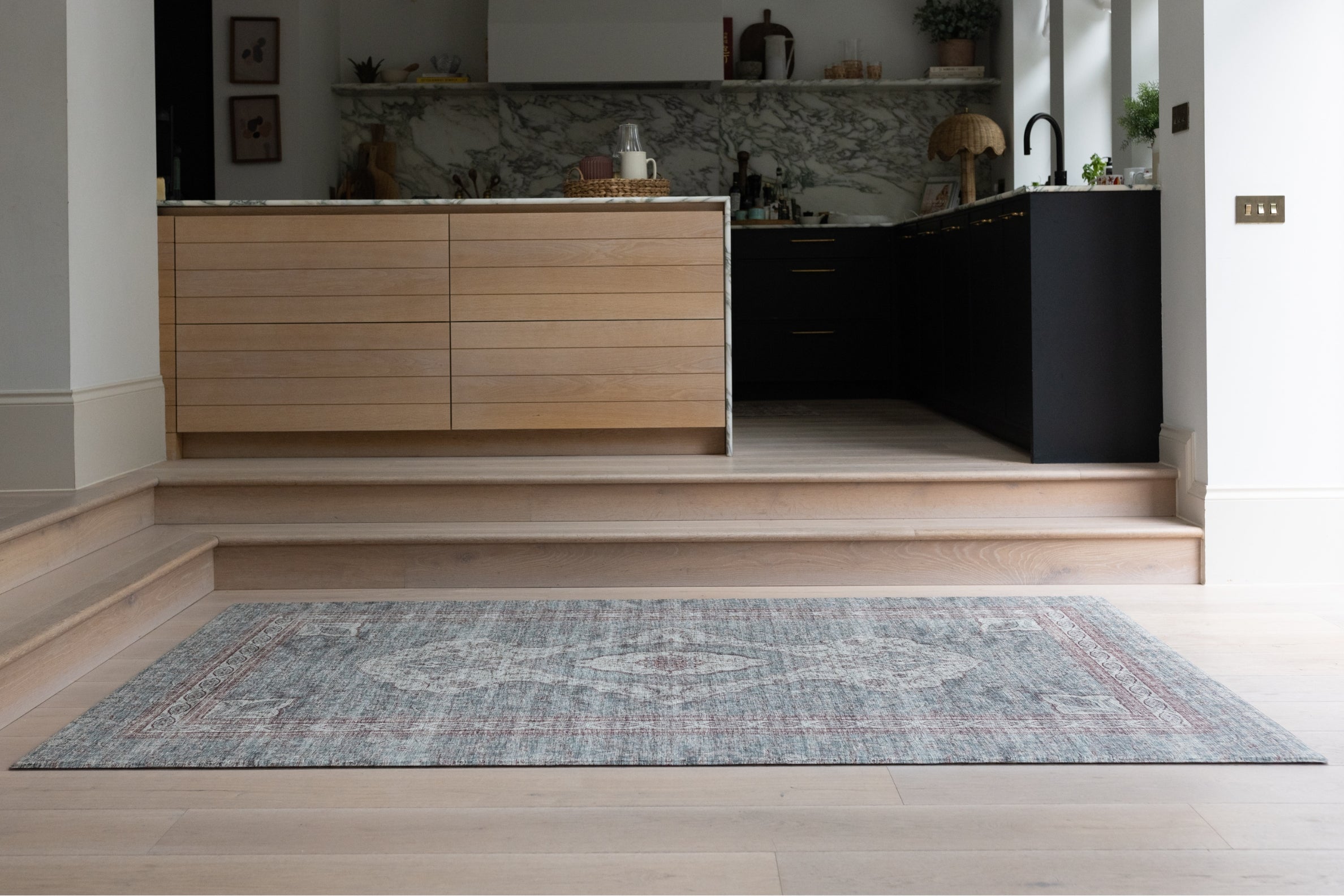 Modern kitchen with a stylish extra large playmat in a Persian rug style