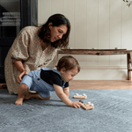 Mother and son enjoy play time on the memory foam spielmatte providing support during baby play time
