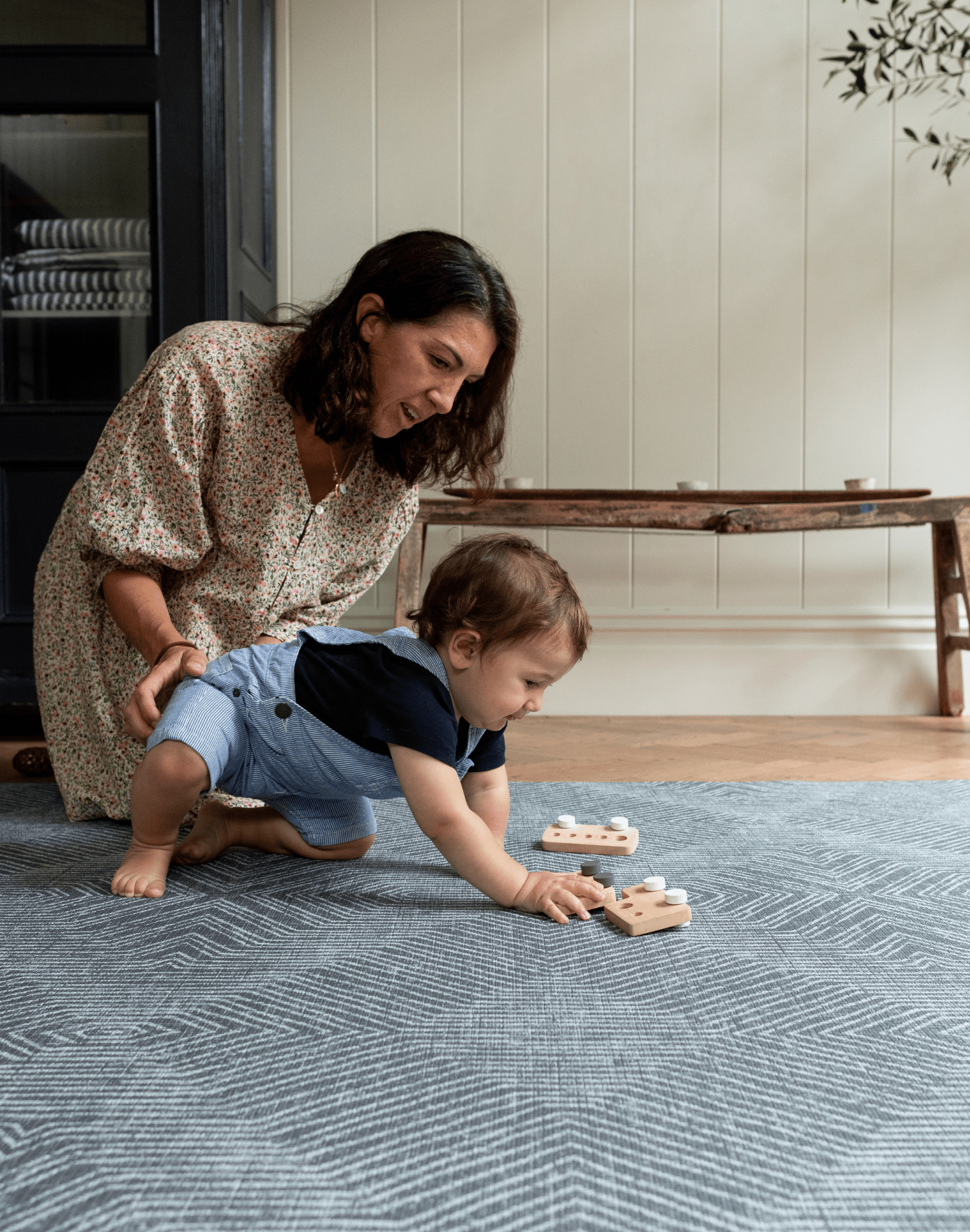 Mother and son enjoy play time on the memory foam spielmatte providing support during baby play time