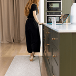 totter + tumble play runner in family kitchen with mom working mother on kitchen standing mat waterproof and washable foam rug in morris & co acorn print
