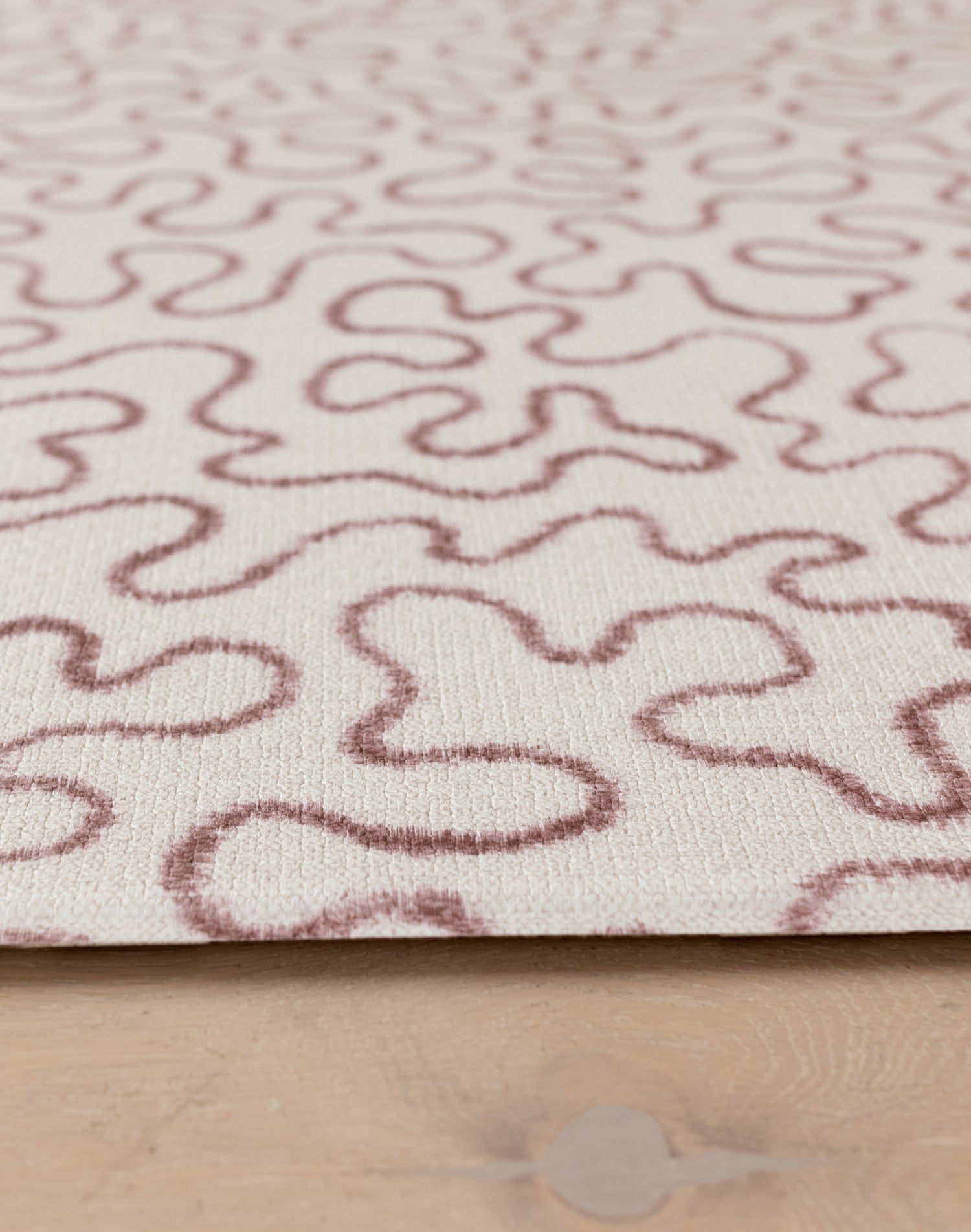 Detail of The Brecon’s abstract pattern playmat, inspired by Welsh heritage and designed in a soothing neutral palette.