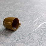 Detail of The Brer Rabbit Playmat’s botanical pattern being wiped clean- a practical yet stylish non-toxic play mat with easy-care surface.