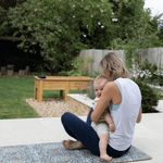blackthorn play runner with mom and baby doing exercise baby yoga outdoors Spielmatte from totter + tumble