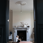 Child enjoys free play on montessori work rug defining a space for montessori play