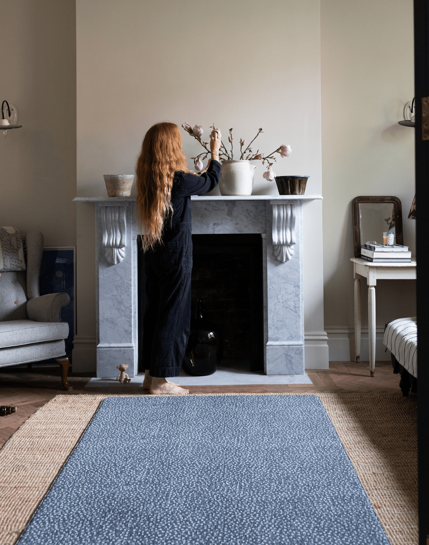 Lady stands next to big baby play mat with a modern motif of leopard print