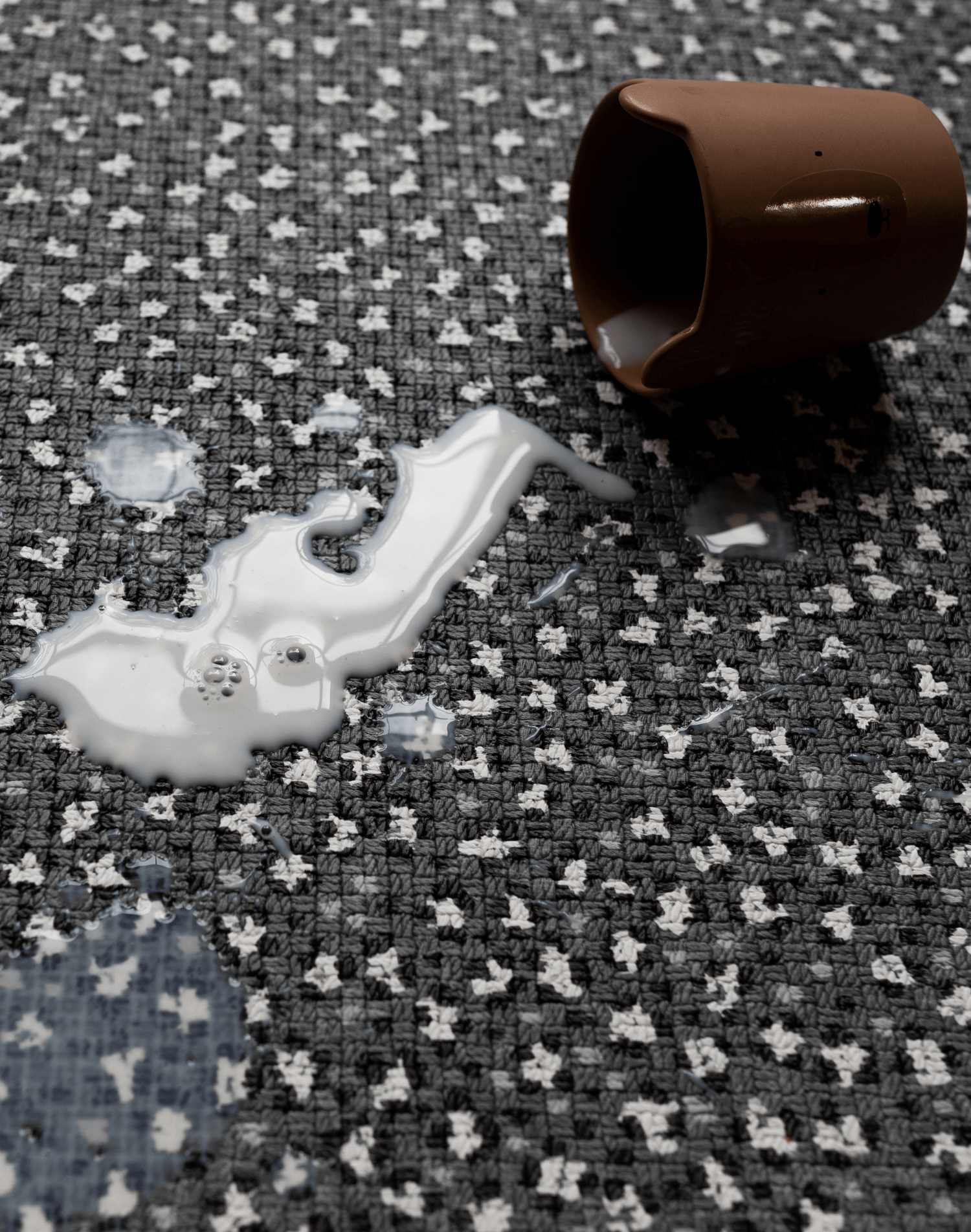 Cup tips over with milk on waterproof durable baby play mat