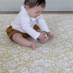 baby playing on padded play mat from totter and tumble comfortable and supportive area rug. waterproof playmat tapis de jeu,