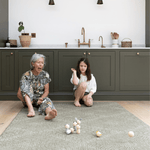 Lady and child enjoy play time together on the keuken mat in green tones to complement the kitchen