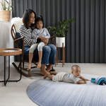 Mother and two children on Large round play mat for modern family homes The Kasuri is stylish with a gradient designs he navy blue play mat is perfect for anywhere in the home