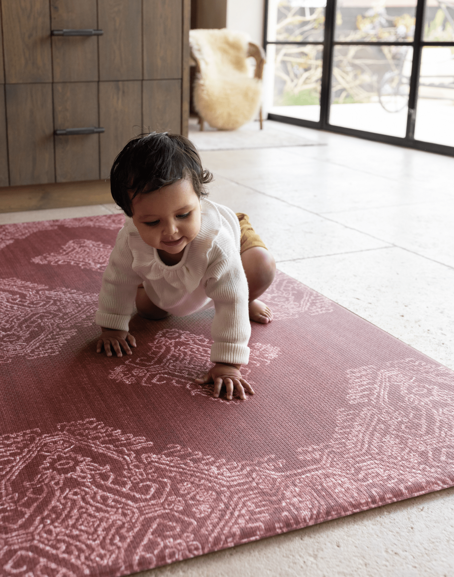 Baby girl crawls across large crawling playmat a spielmatte ideal for anywhere in the home thick design for tiled flooring