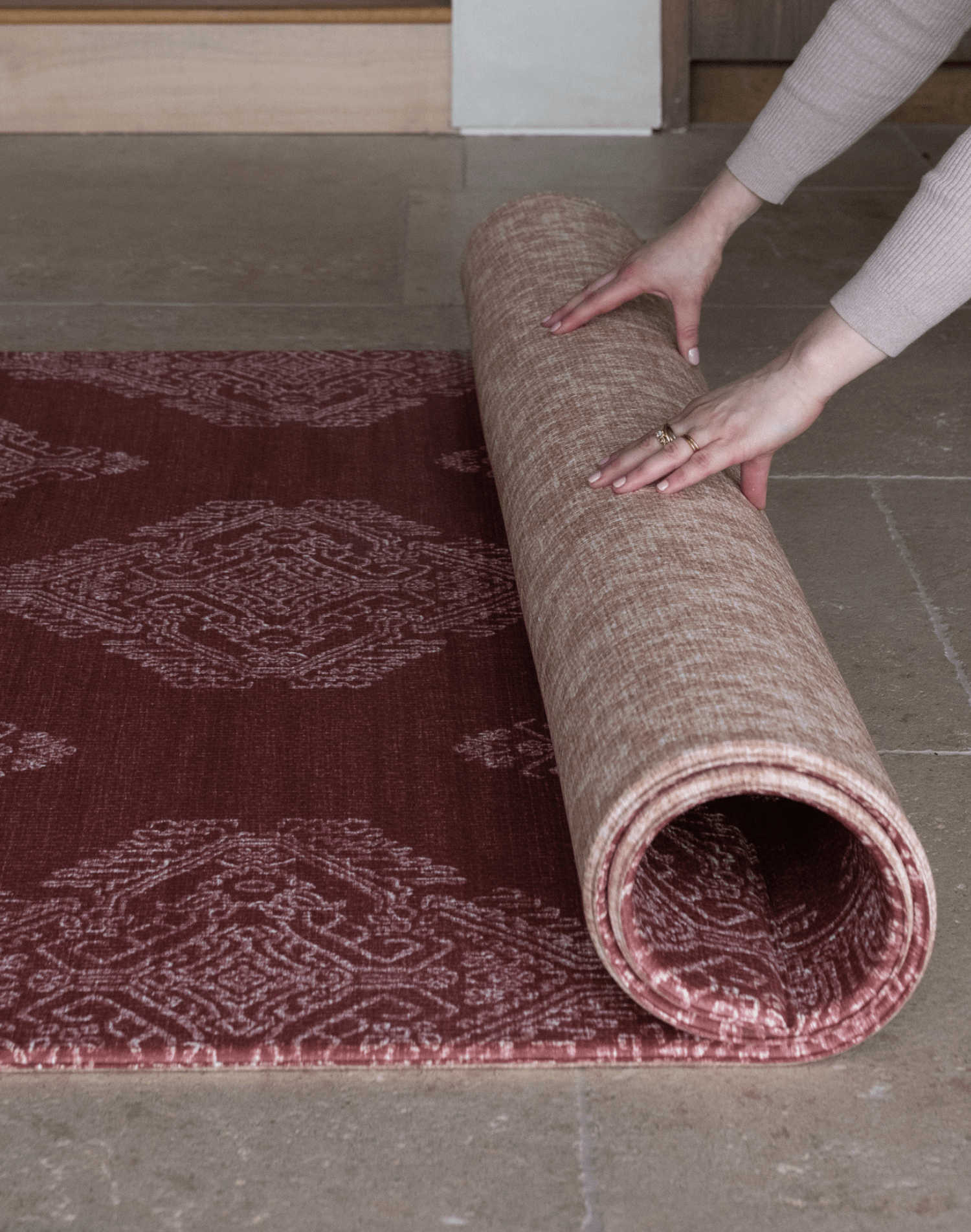 Hands unroll reversible thick play mat with stylish red and tan designs for stylish family homes unroll for practicality and style