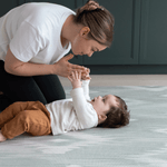 Mother and baby enjoying floor time on Thick memory foam mat for babies and adults designed for modern homes with artisan Ikat print in green and grey shades