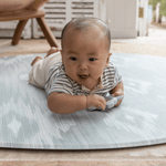 Round play mat for hard floors by Totter and Tumble so little ones don't feel the floor underneath with stylish green and beige ikat design for a stylish look
