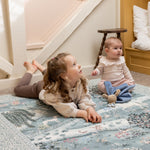 Two children playing on a Totter + Tumble luxury play mat, perfect for high-end baby accessories in compact spaces.