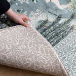 Detailed corner fold of a reversible Totter + Tumble foam play mat  showcasing durable materials and classic Morris & Co. floral heritage prints.