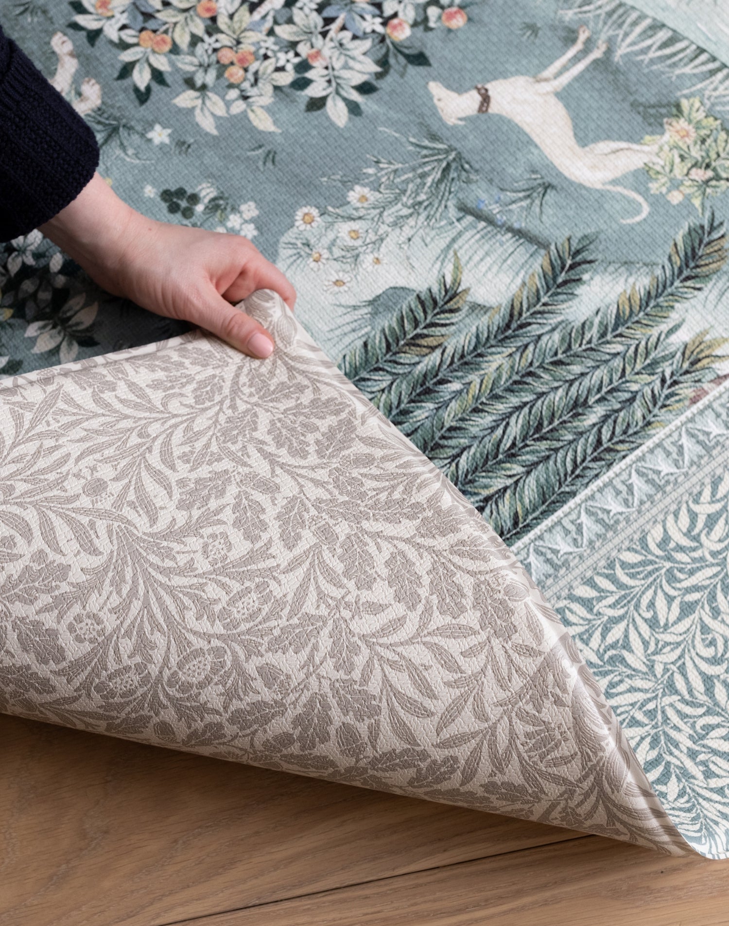 Detailed corner fold of a reversible Totter + Tumble foam play mat showcasing durable materials and classic Morris & Co. floral heritage prints.
