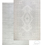 An extra large soft playmat with a stylish design on two sides. The front side shows a grey Persian rug style with an intricate border and the reverse is a Batik print pattern