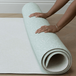 Unrolling the memory foam speelmat by Totter and Tumble with the subtle Rambler and Globe Trotter designs