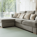 A living room looks modern with a green play mat that brings nature into the home