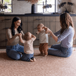 Mums and babies play on large crawling play mat padded to support and protect on the tiled flooring while complementing the modern interior
