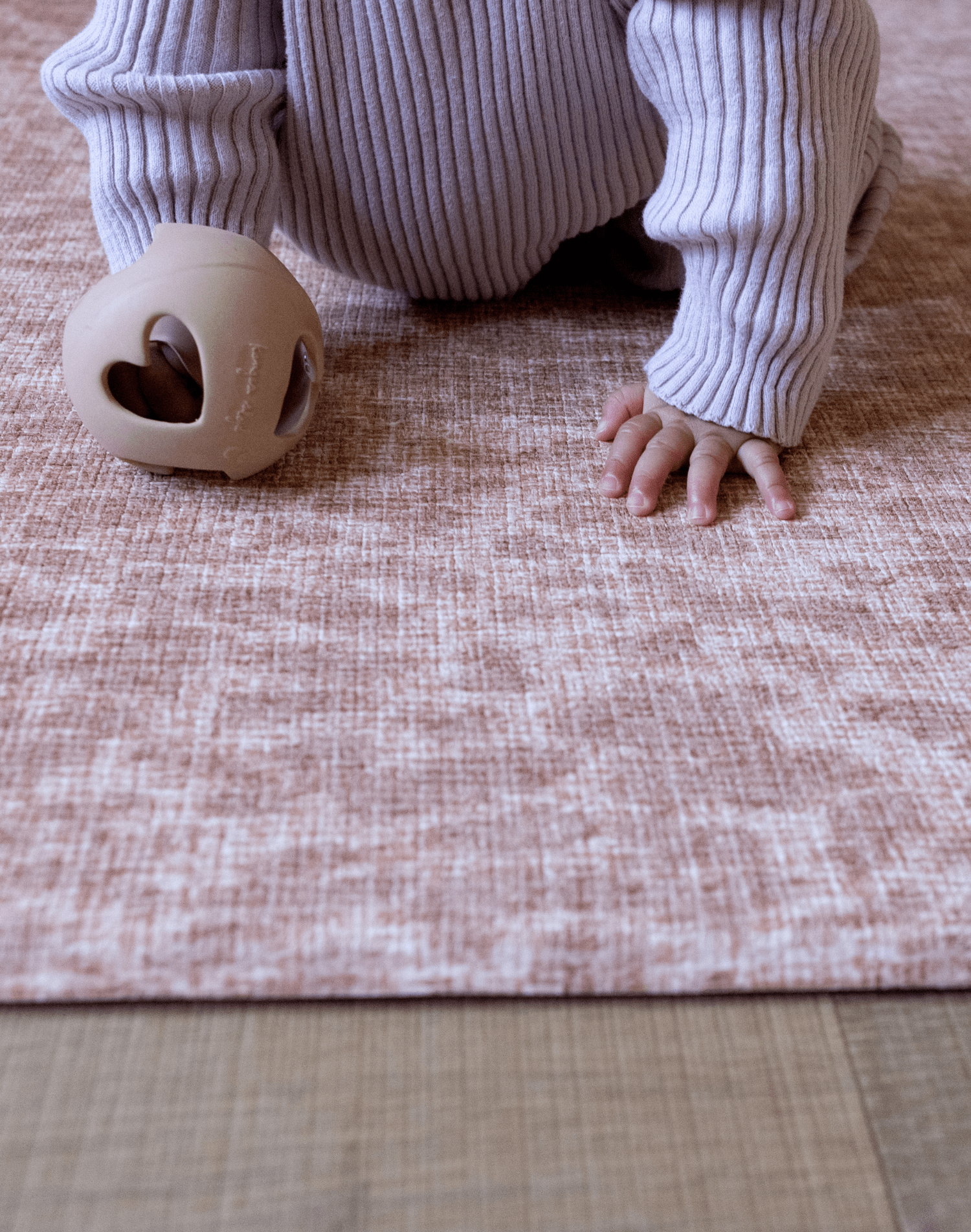 Baby support during crawling and tummy time on the supportive play mat by totter and tumble with a textural animal print design that looks modern in the family home while also offering floor time protection