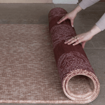 Unrolling double sided red and tan play mat made with thick padded memory foam for ultimate support on tiled flooring