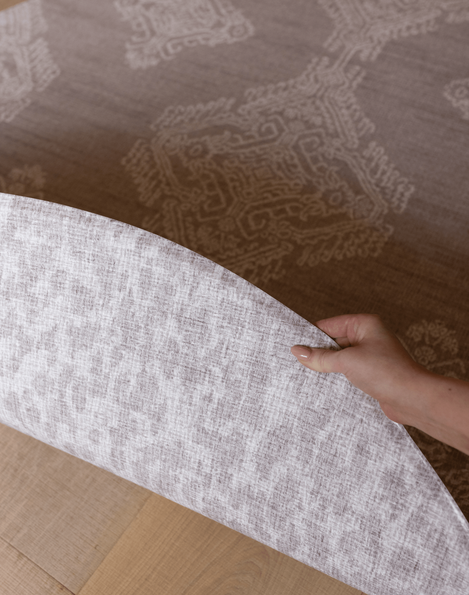 Hand pulls back the double sided grey playmat designed for the whole family to take to the floor in comfort textural patterns and subtle colourways designed with modern homes in mind