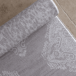Close up of the Soft grey playmat design the sepi by totter and tumble with a batik inspired textile effect to look like a rug in the home playmats for family homes available in four sizes