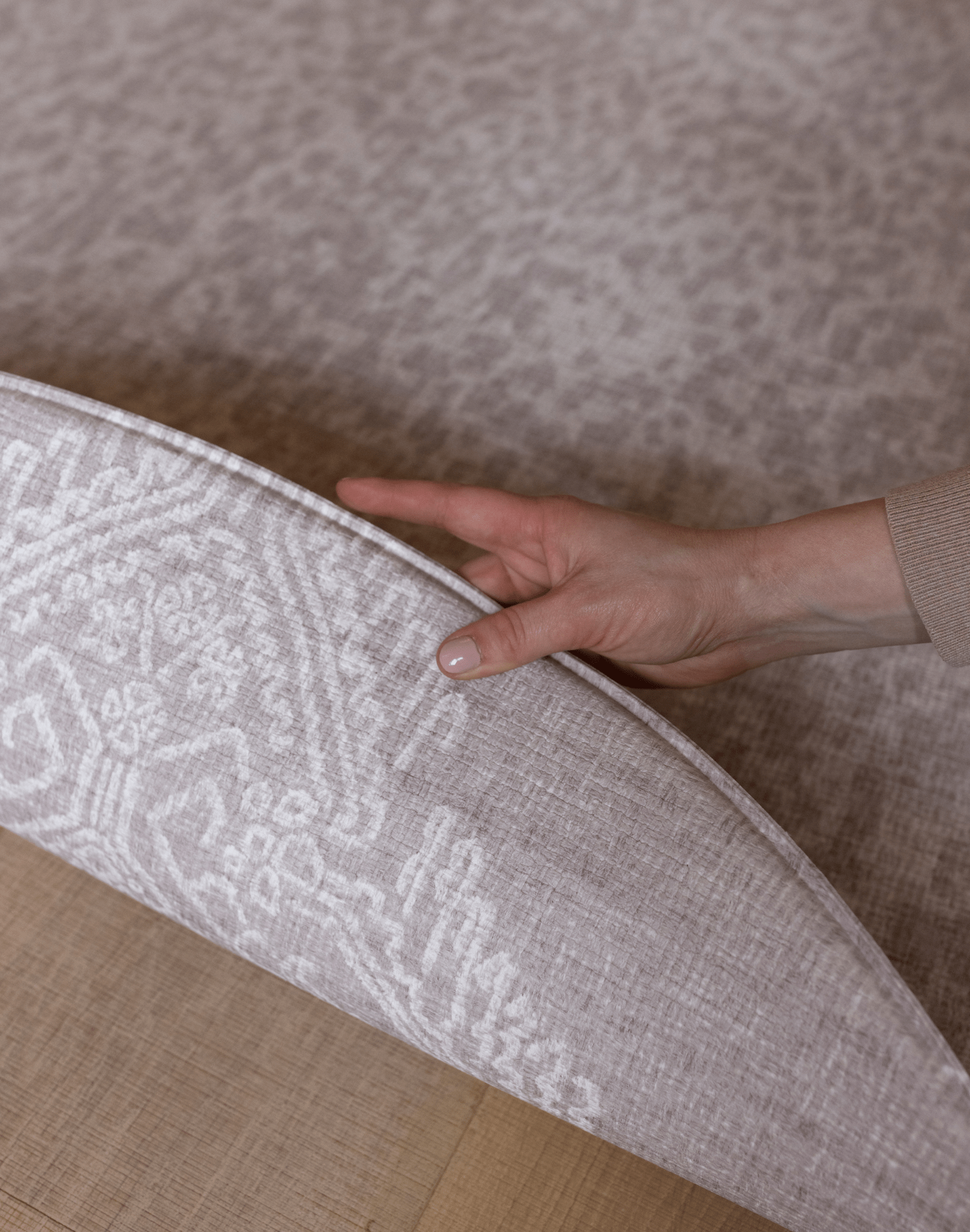 Hand pulls back the reversible padded playmat the sunda with two grey designs with modern motifs for the contemporary family home thick memory foam is ideal for keeping the family comfy during floorplay