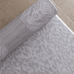 Close up of the double sided grey playmat with two textural designs to look good in modern family homes luxury memory foam provides protection for the family on the floor enjoying playtime and exercise