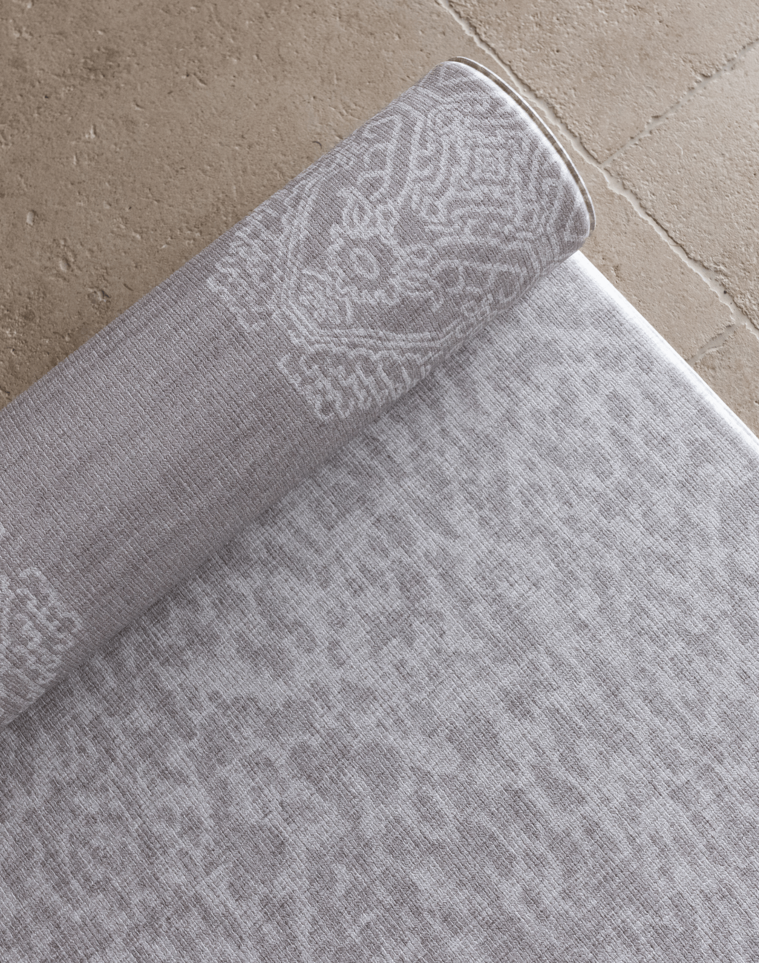 Close up of the double sided grey playmat with two textural designs to look good in modern family homes luxury memory foam provides protection for the family on the floor enjoying playtime and exercise