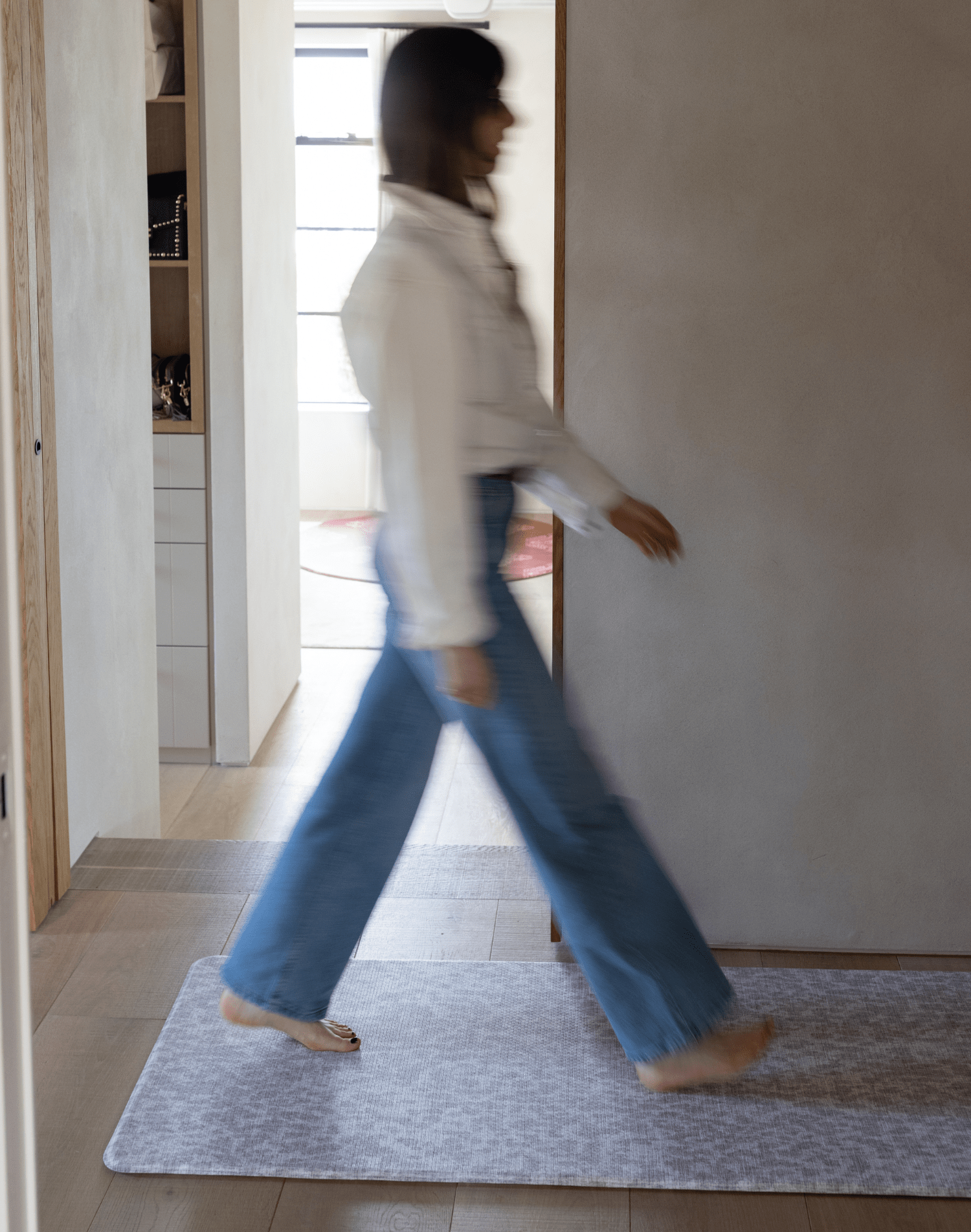 lady walks across the sealed memory foam hallway runner thick and comfortable to keep the household supported and to keep feet off cold flooring versatile mat design ideal as a kitchen mat large bathroom mat and padded exercise mat