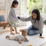 Mother and children on Round play mat for hard floors by Totter and Tumble so little ones don't feel the floor underneath with stylish tan and cream design for a stylish look