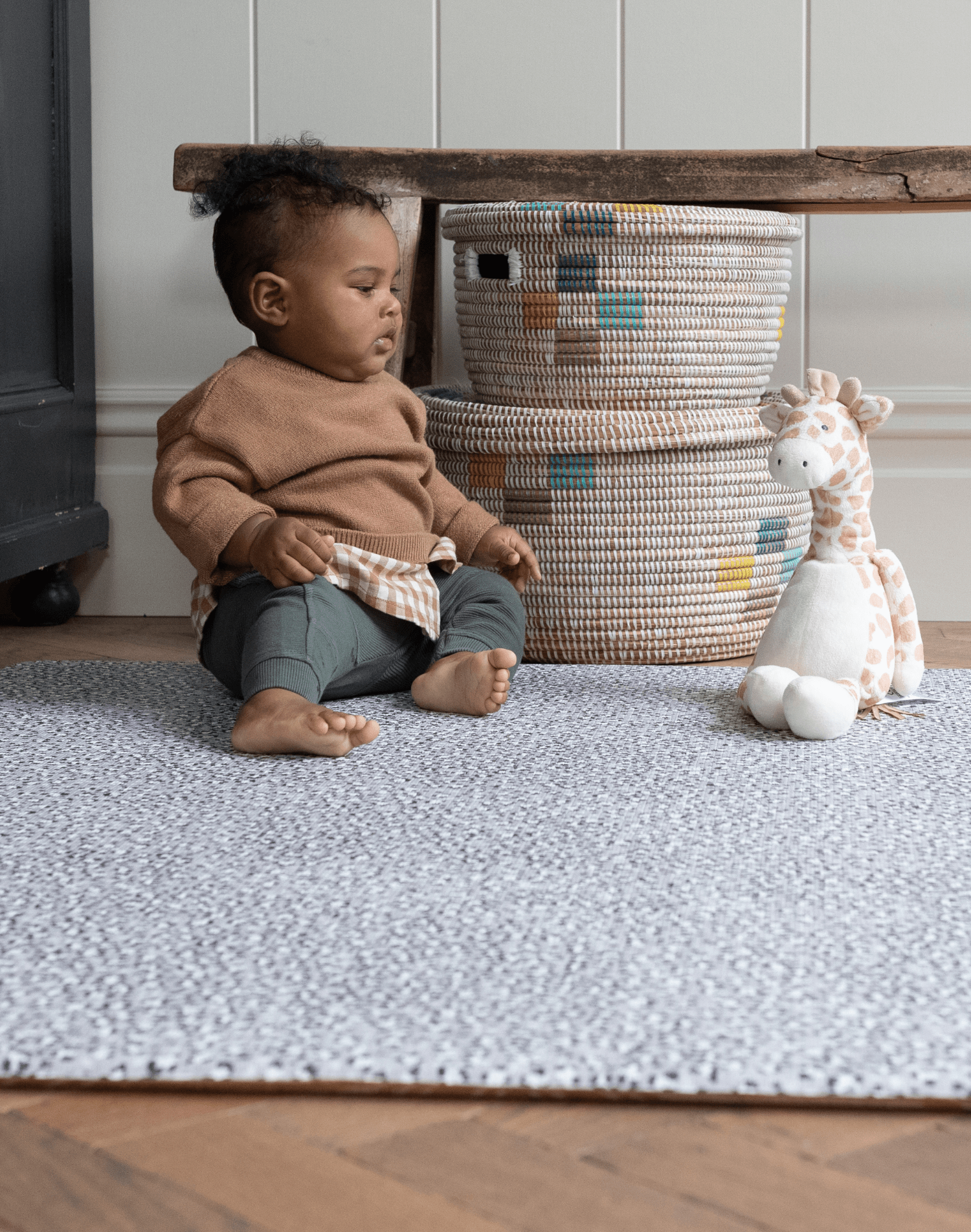 Little boy plays with soft toy on thickly padded playmat ideal for playtime