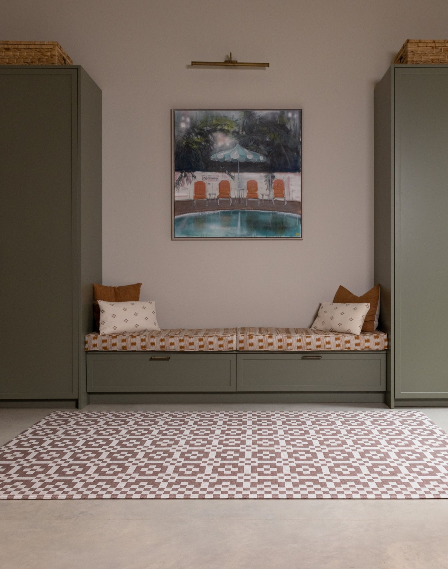Room interior with the Totter + Tumble Weaver crawling mat for babies. A heritage-inspired playmat in earthy brown red tones.