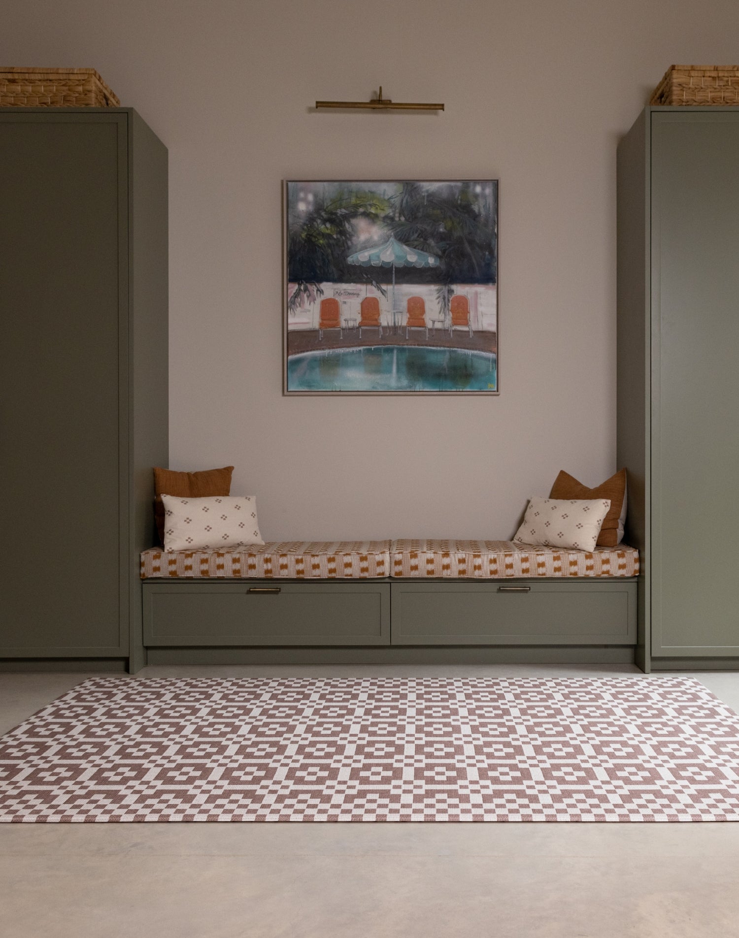 Room interior with the Totter + Tumble Weaver crawling mat for babies. A heritage-inspired playmat in earthy brown red tones.