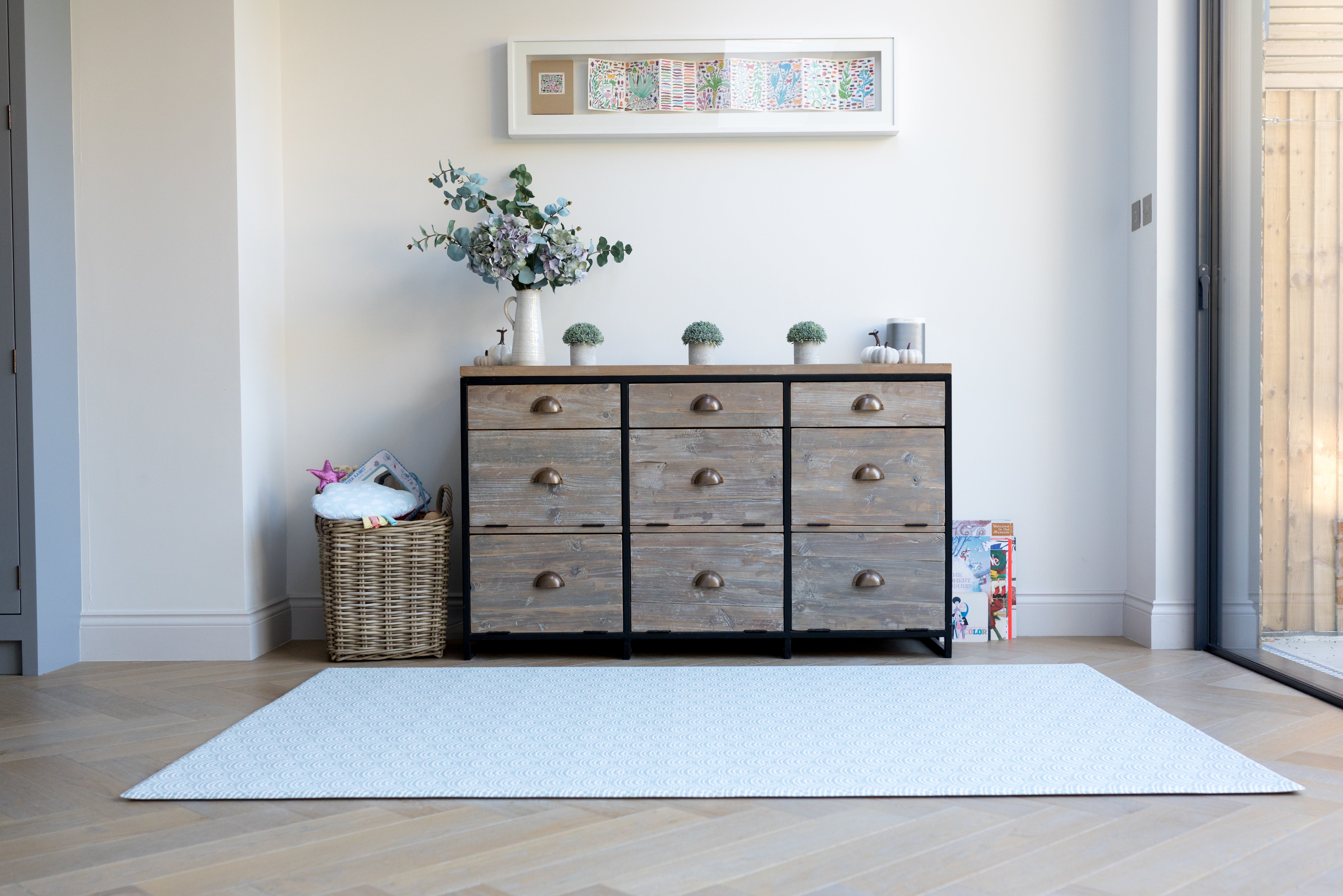 A tranquil blue patterned large playmat in a living space