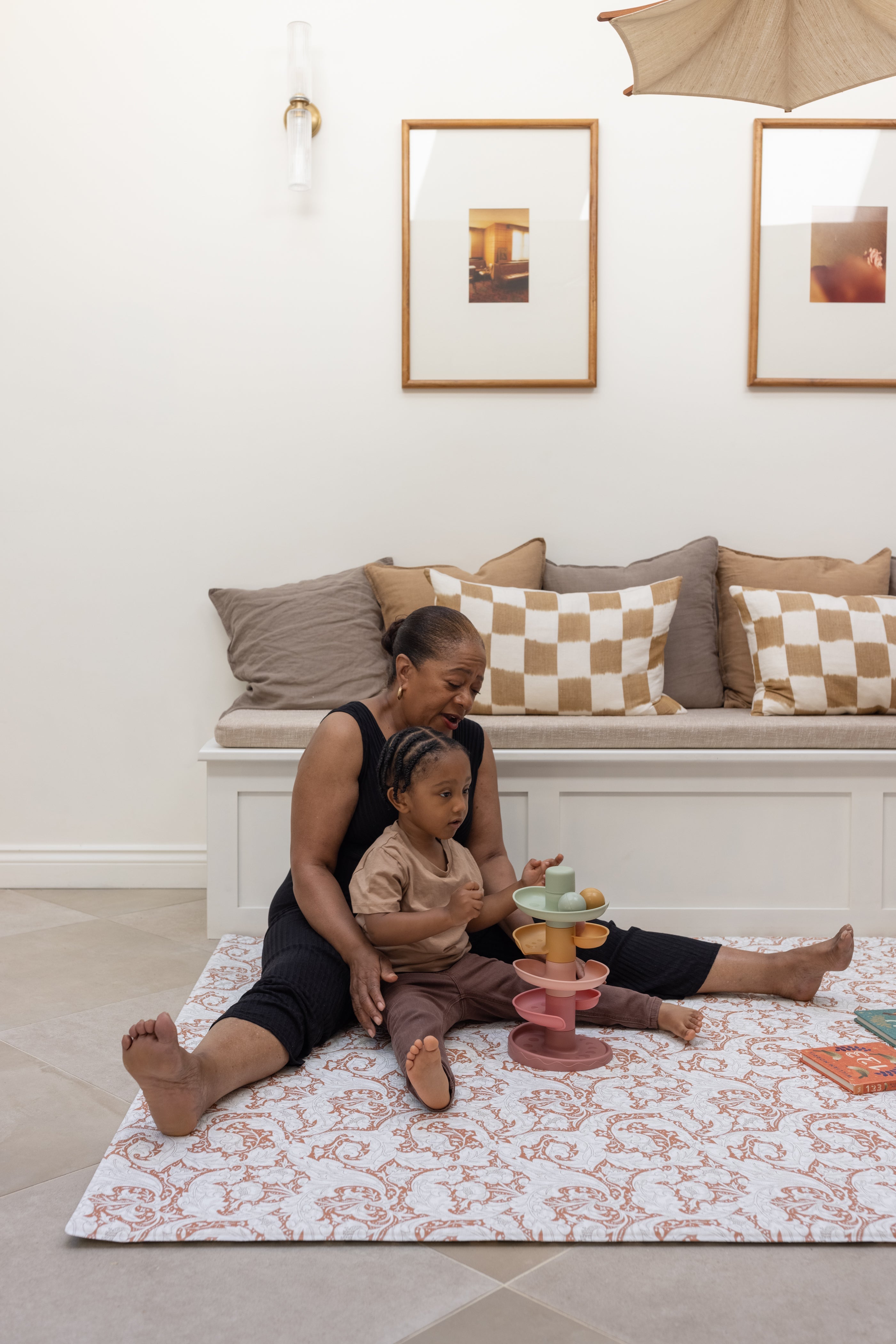 family playing on a soft supportive totter and tumble memory foam playmat