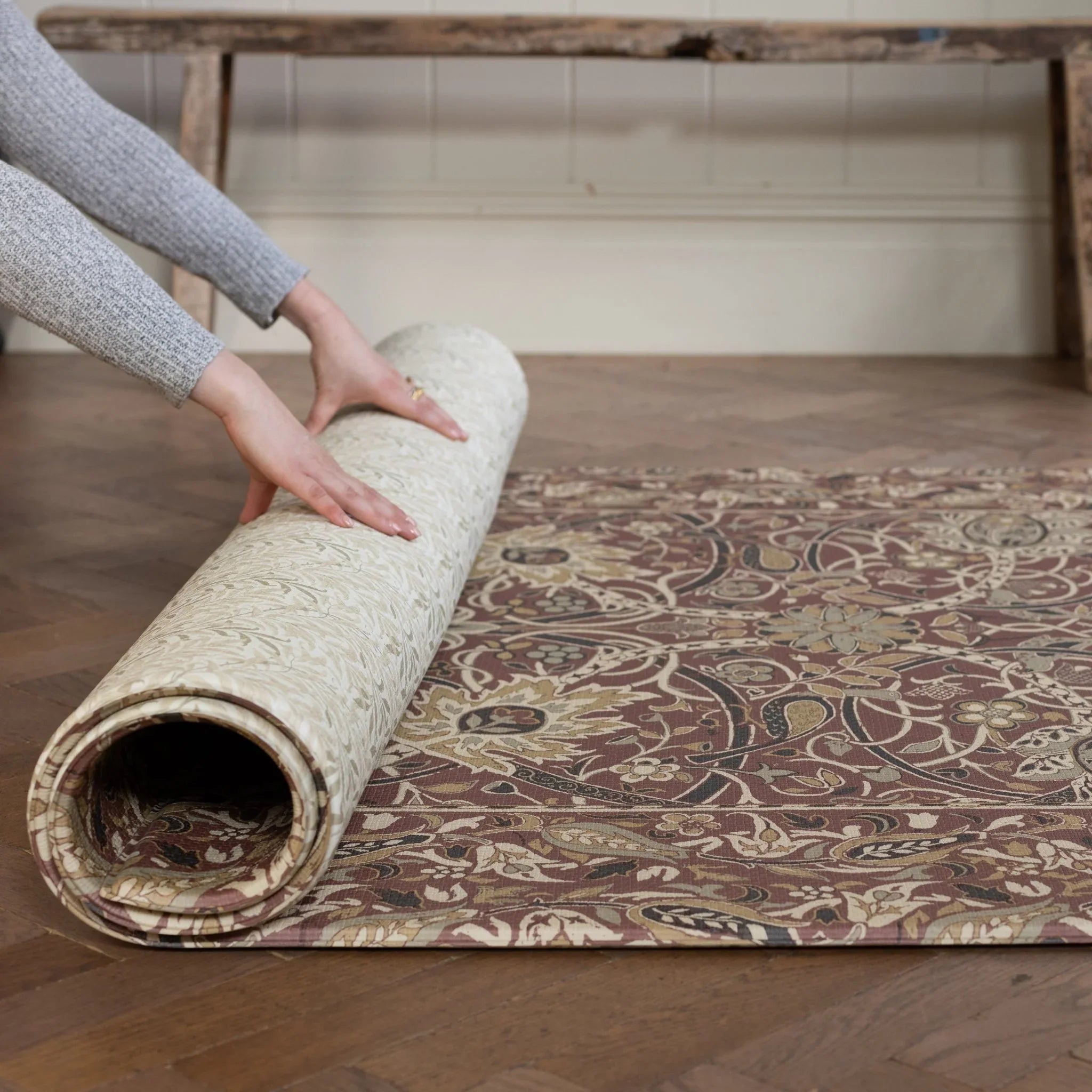 Rolled decorative playmat in rich madder and gold tones. 