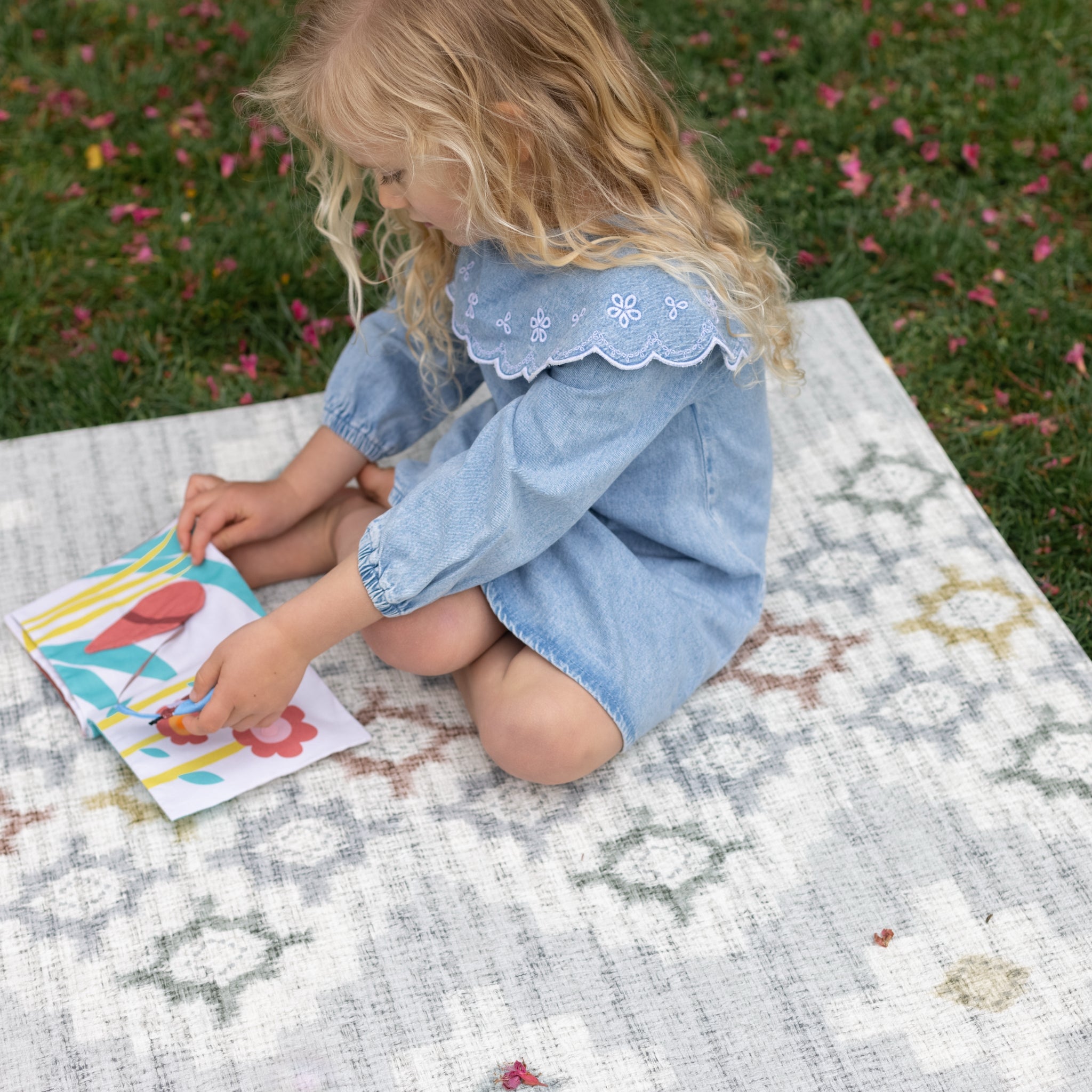 Child playing outside on a memory foam safe non toxic playmat