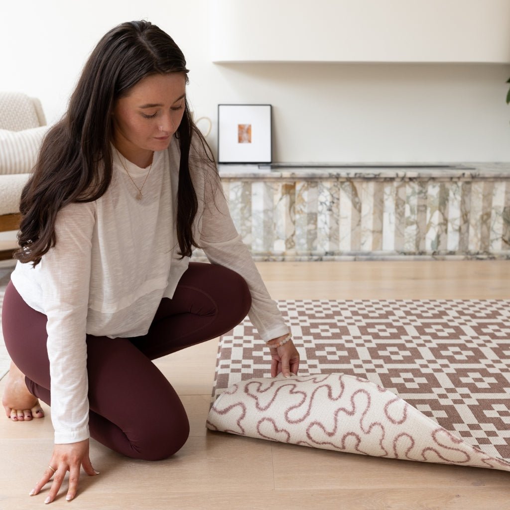 Mum picks up a wipeable baby play mat in tufted texture