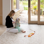 Woman and child playing on a floral botanical baby play mat for hardwood floors