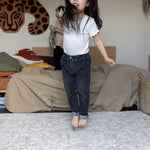 Child jumping on a luxury foam play mat that blends into living room decor