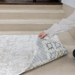 Person rolling out a reversible baby play mat for hardwood floors