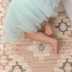 child crawling on a chic baby play mat that matches home decor