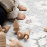 Wooden toys on a luxury foam play mat that blends into living room decor