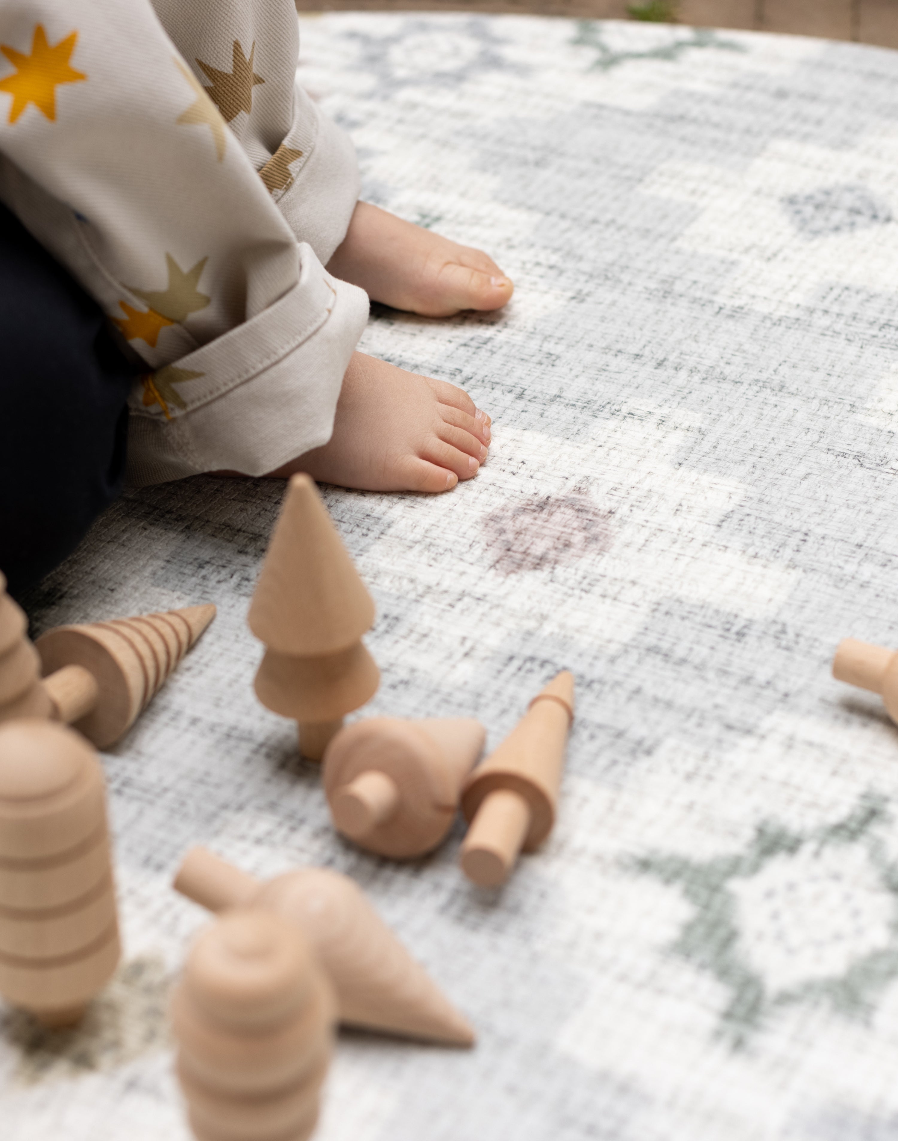 Wooden toys on a luxury foam play mat that blends into living room decor