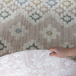 person showing both sides of a pink luxury reversible play mat